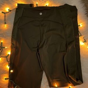 Lululemon Dark Olive Green Legging 25” with design and mesh on sides.